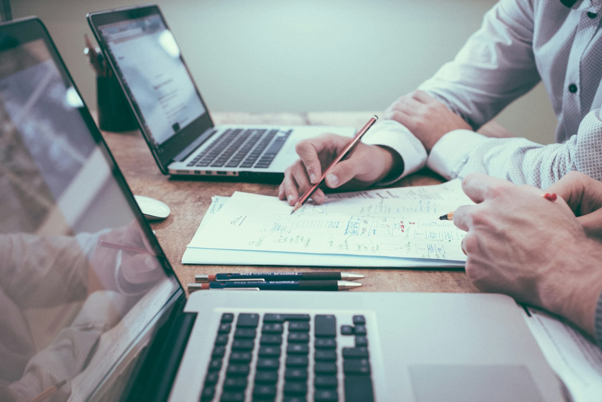 Laptop and papers on a desk — opening a UAE bank account after you land